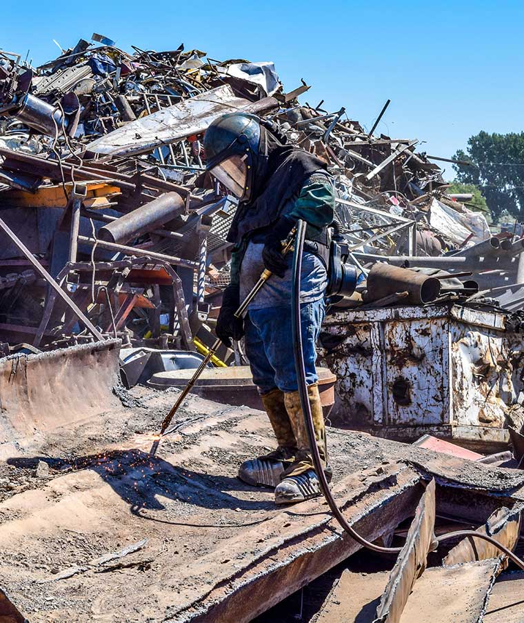 Man holding a tracker on a dumpster